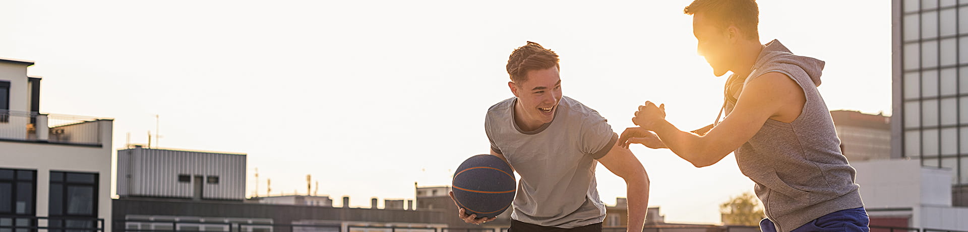 "two men playing basketball"