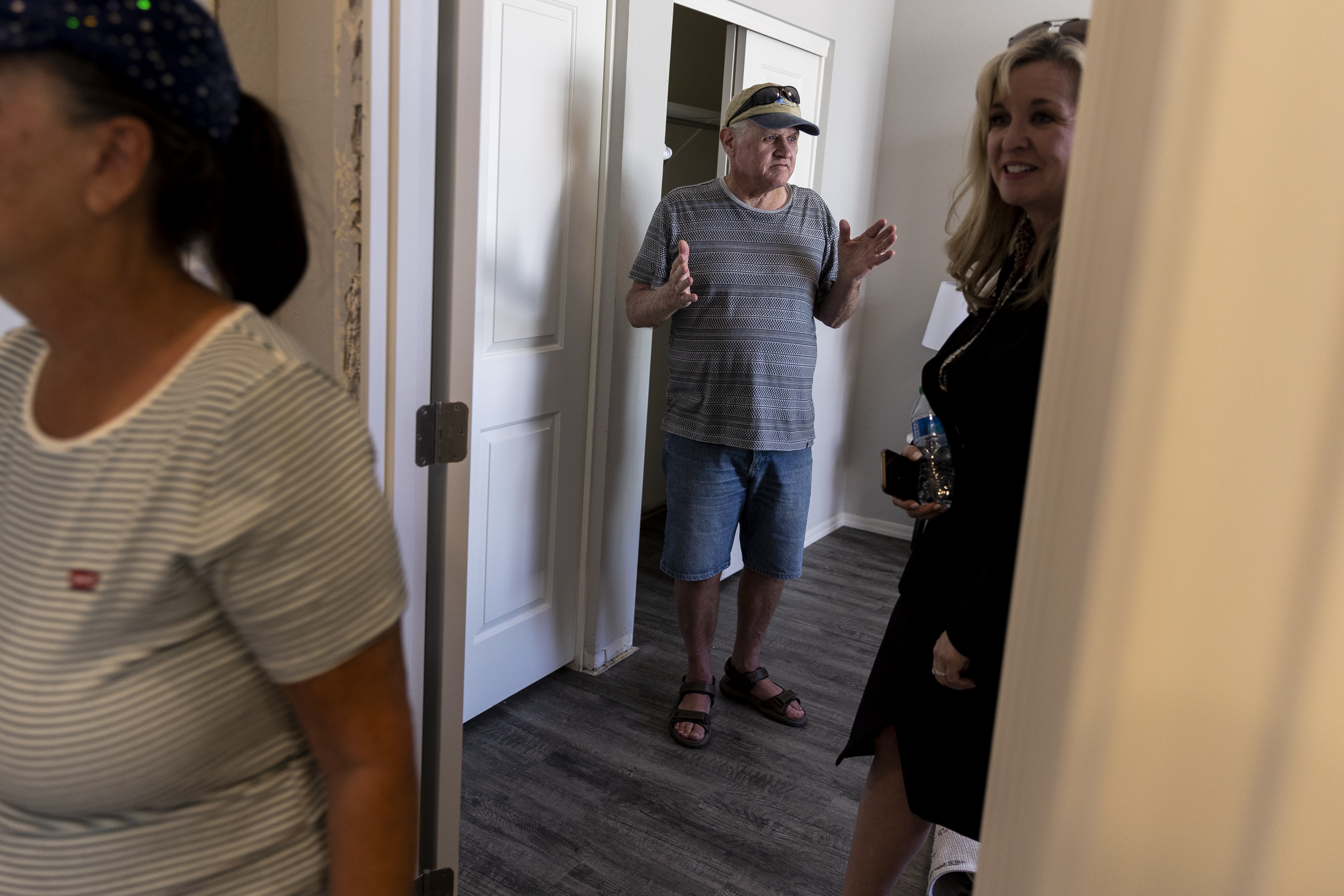 Cancer patient Jac Conant gestures as he tours his new home