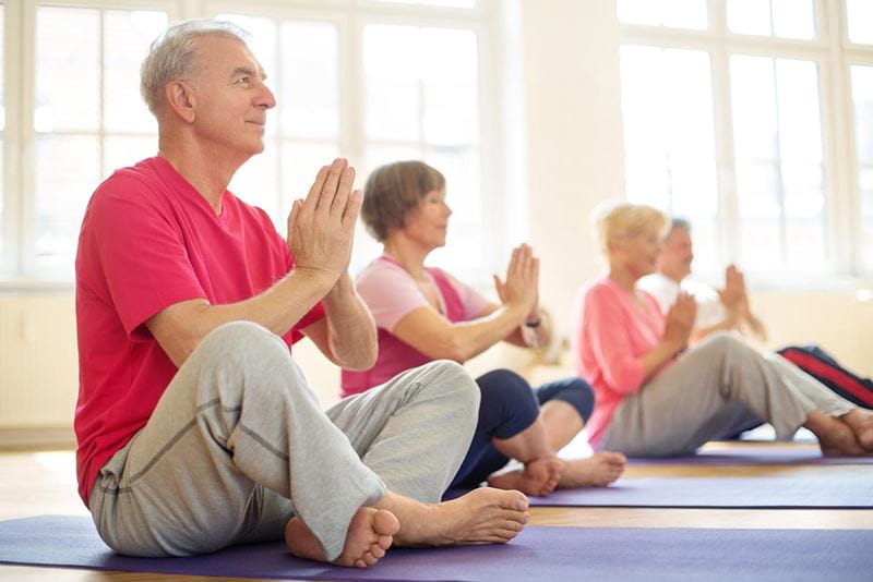 5-elderly-practicing-yoga-in-class